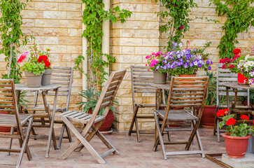 Fototapeta na wymiar Chairs in the garden restaurant in Leptokarya, Greece.