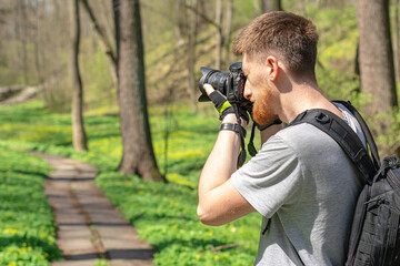 Male photographer with camera take photo