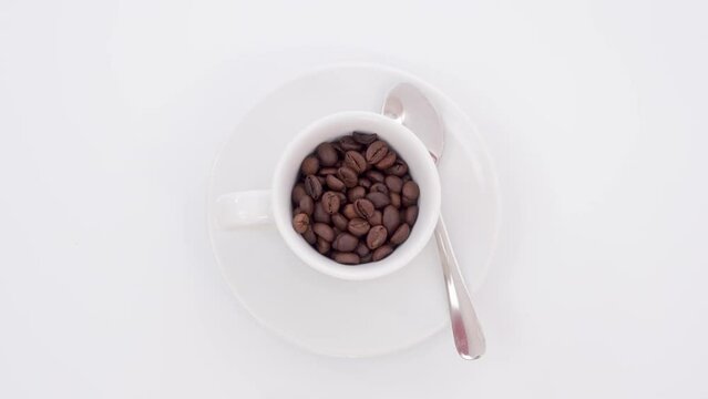 Stop motion animation of a coffee cup being filled with beans turns into espresso