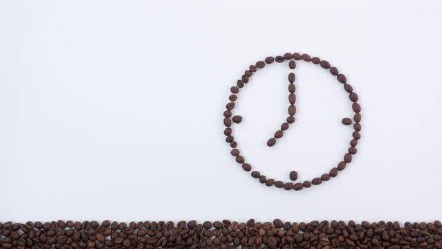 Clock made from coffee beans and a cup of espresso stop motion animation coffee time concept.