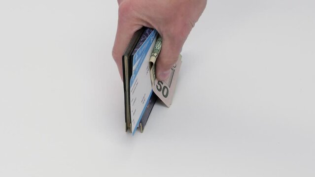 Male hand takes money, plane tickets and passports before travel