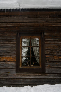 Reindeer Antlers in a Window of a Wooden Cabin