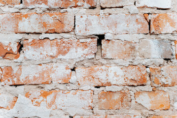 Old stone wall made of red dirty bricks, close-up. Rough texture background