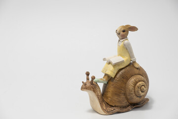 White Easter bunny rabbit with shopping basket and painted eggs on blue and pink background