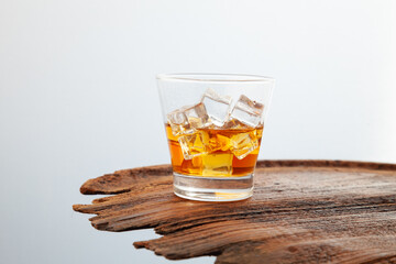 Whiskey or alcoholic beverages or bourbon with ice on the wooden floor and a black and white scene with a top view