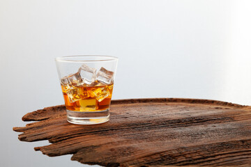 Whiskey or alcoholic beverages or bourbon with ice on the wooden floor and a black and white scene with a top view