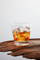 Whiskey or alcoholic beverages or bourbon with ice on the wooden floor and a black and white scene with a top view