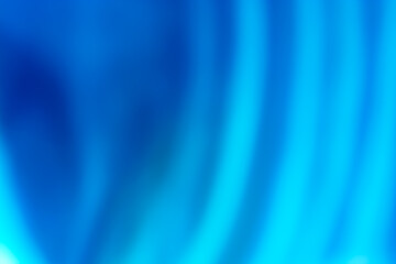 Abstract blue background from a heavily blurred curtain.
