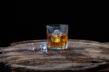 Whiskey or alcoholic beverages or bourbon with ice on the wooden floor and a black and white scene with a top view