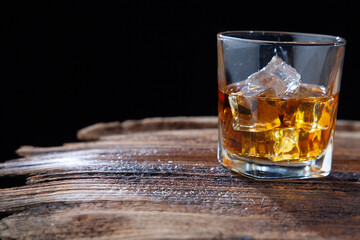 Whiskey or alcoholic beverages or bourbon with ice on the wooden floor and a black and white scene with a top view