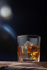 Whiskey or alcoholic beverages or bourbon with ice on the wooden floor and a black and white scene with a top view