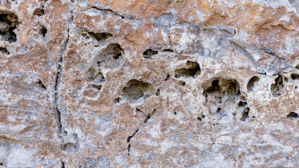Old marble background. Stone texture with spots and cracks. Cracked vintage wall