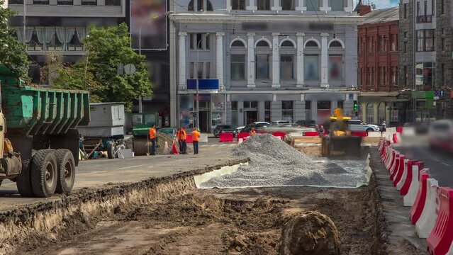 Industrial truck loader excavator moving soil and unloading into a dumper truck timelapse
