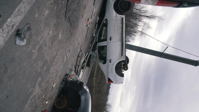 overturned and broken cars on the road