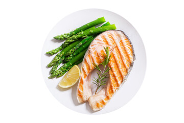 plate of grilled salmon steak with asparagus isolated on white background