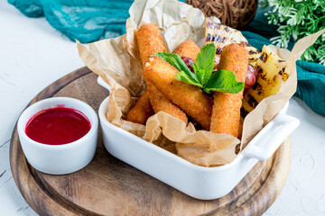 fried Cheese sticks with berry sauce on the board