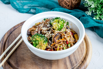 fried noodles soba with vegetables and broccoli on white bowl (buckwheat noodles)