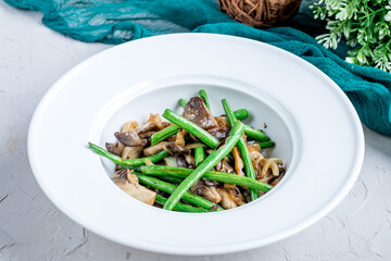 fried oyster mushrooms with green beans on white bowl