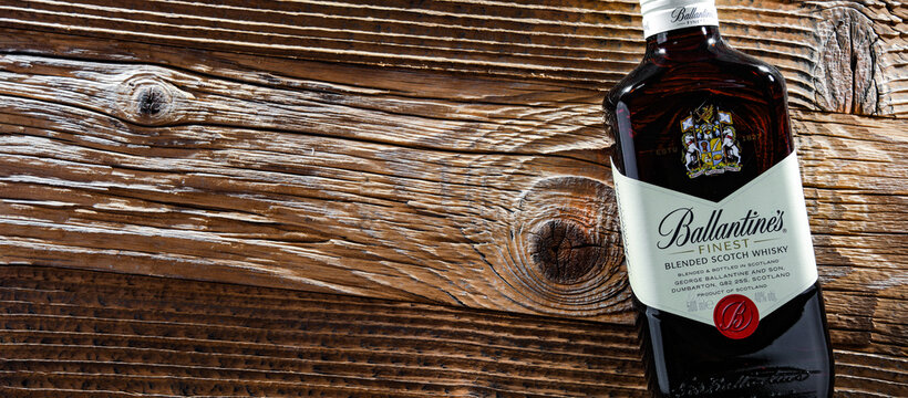 Bottle of Ballantine's scotch whisky on a wooden table