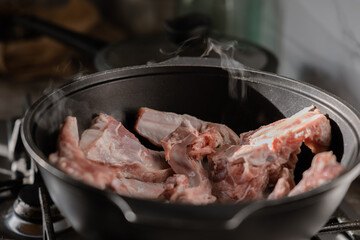 Chopped onions and pieces of meat are fried in boiling oil. Cooking pilaf in a cauldron, a step-by-step recipe for real pilaf.