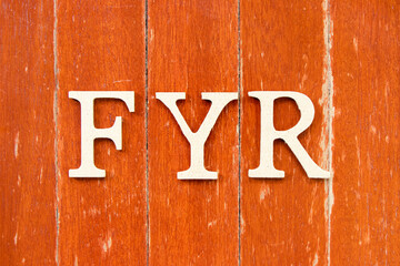 Alphabet letter in word FYR (abbreviation of for your reference) on old red color wood plate background