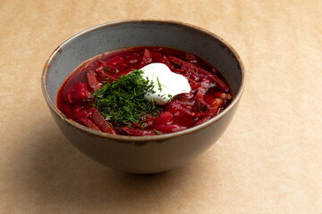 Traditional borscht soup. On a brown background.