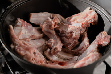 Chopped onions and pieces of meat are fried in boiling oil. Cooking pilaf in a cauldron, a step-by-step recipe for real pilaf.