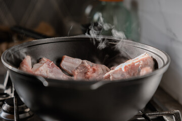 Chopped onions and pieces of meat are fried in boiling oil. Cooking pilaf in a cauldron, a step-by-step recipe for real pilaf.