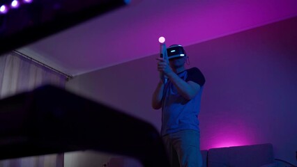 Man with virtual reality headset and joystic is playing game - Powered by Adobe