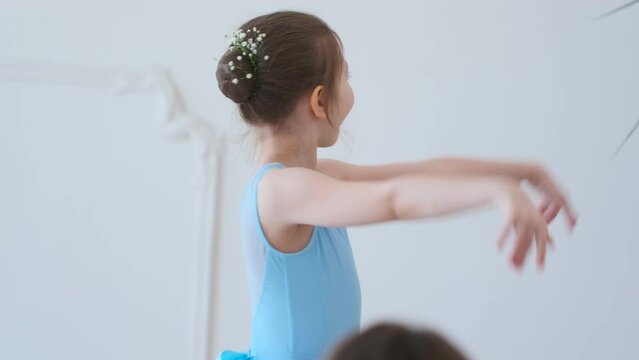 Girl young from ballet dancing ballet in white studio. Pretty graceful ballering doing elements of classical ballet - arts concept 4k footage