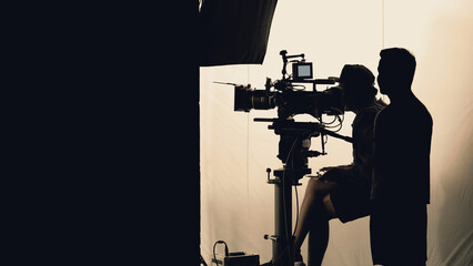Video production behind the scenes which film crew team in silhouette shooting or recording tv...