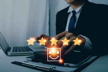 Fototapeta na wymiar Customer service satisfaction survey concept.Business people or customers show satisfaction through the application on the tablet screen. By giving the most satisfaction rating and 5 stars.