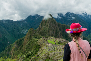 Fototapeta na wymiar Photograph of Machu Picchu. Woman with Inca hat in the mountains