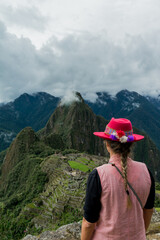 Fototapeta na wymiar Photograph of Machu Picchu. Woman with Inca hat in the mountains