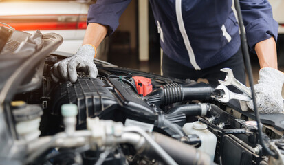 Automobile mechanic repairman hands repairing a car engine automotive workshop with a wrench, car service and maintenance,Repair service.