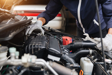 Automobile mechanic repairman hands repairing a car engine automotive workshop with a wrench, car service and maintenance,Repair service.