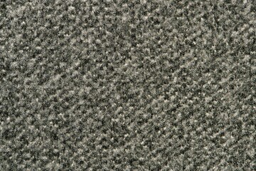 Dark gray swatch of carpet sample, closeup directly above full frame image.