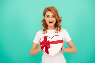 amazed woman hold heart present box on blue background