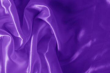 The texture of the proton purple cloth with waves and shrugs. Shiny fabric.