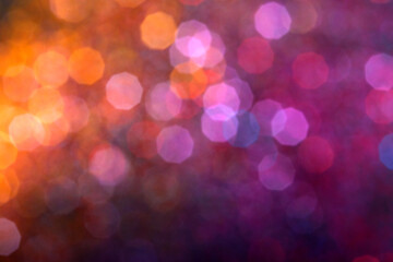 Blur sparkles. Defocused pink orange purple color gradient shiny grain texture on dark background. Bokeh glow lights for backgrounds, compositions and overlays.