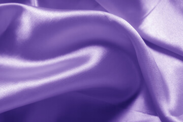 Obraz premium The texture of the proton purple cloth with waves and shrugs. Shiny fabric.