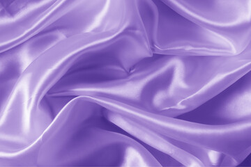The texture of the proton purple cloth with waves and shrugs. Shiny fabric.