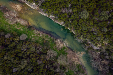 looking down nature stream greenbelt with trees in summer