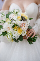 Bride holding beautiful white wedding bouquet. Closeup