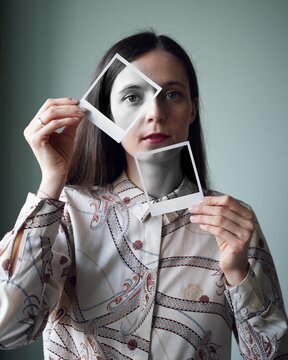 portrait of a woman. Girl looking at photos. Printed polaroid photos