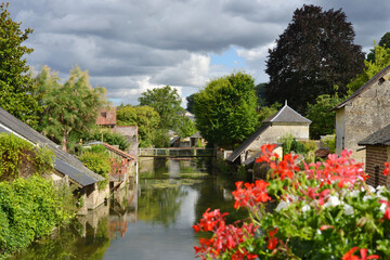 Fototapeta na wymiar Loir river in La Chartre sur Loir in France traditional architecture and bridges