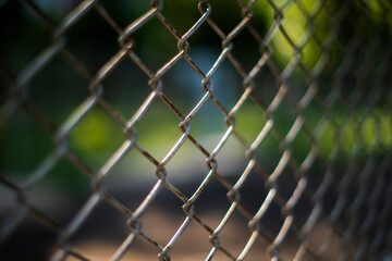 Naklejka premium Close-up chain link fence , Sunset background