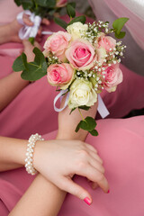 Young female hands holding a bouquet of roses