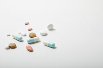 loose multi coloured tablets isolated on a white background