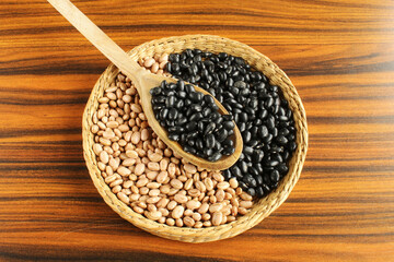Brazilian beans spoon. Carioca beans and black beans in a wicker basket.